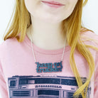 Eliza wears a Keep on Truckin' necklace in slate.