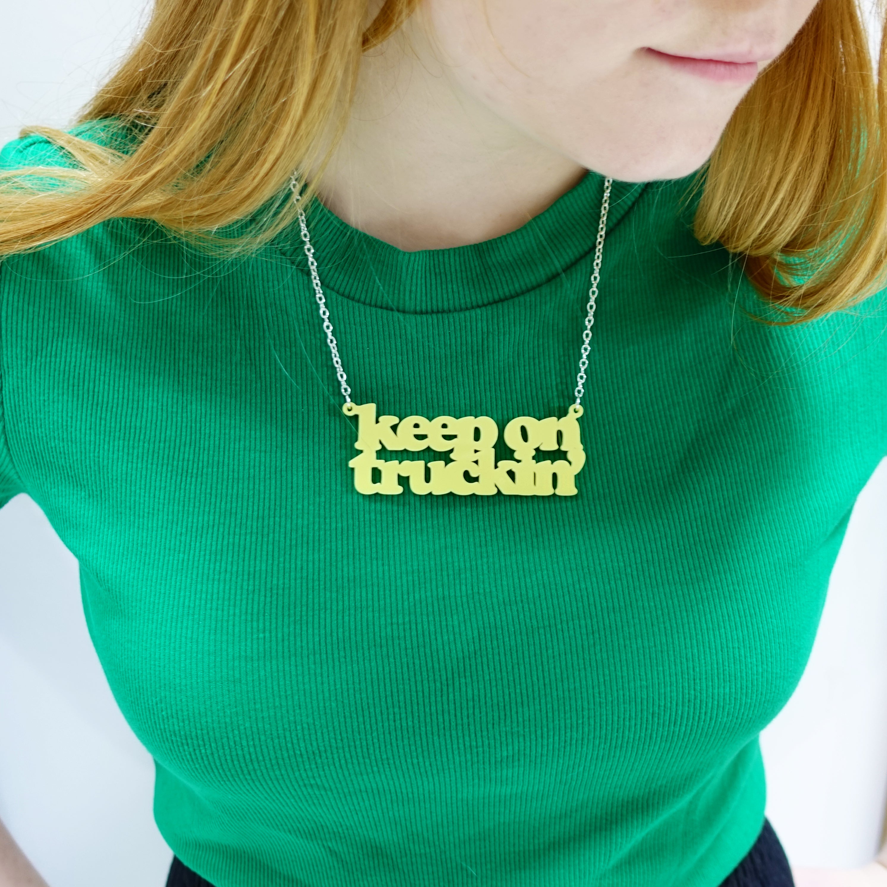 Eliza wears a Keep on Truckin' necklace in lemon drop.