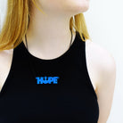 Eliza wears Rebel Alliance Hope necklace in vote blue.