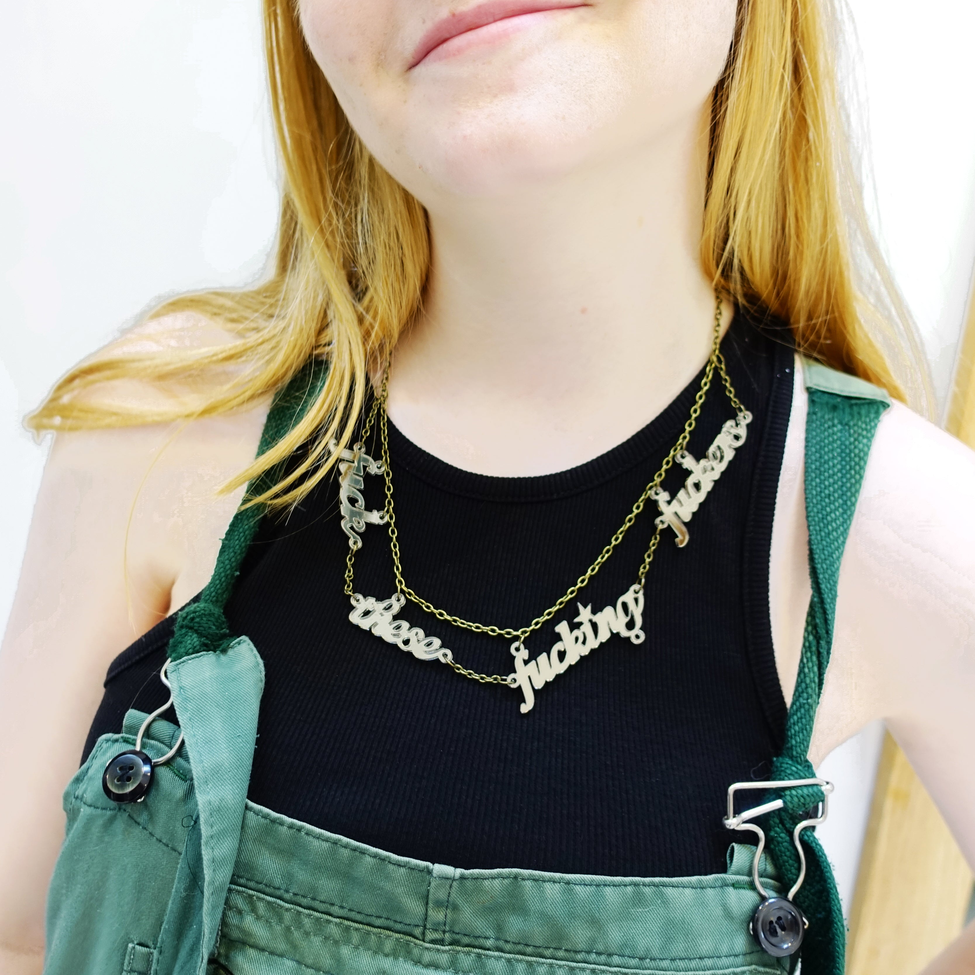 Eliza wears a F*ck these F*cking F*ckers necklace in bronze mirror.