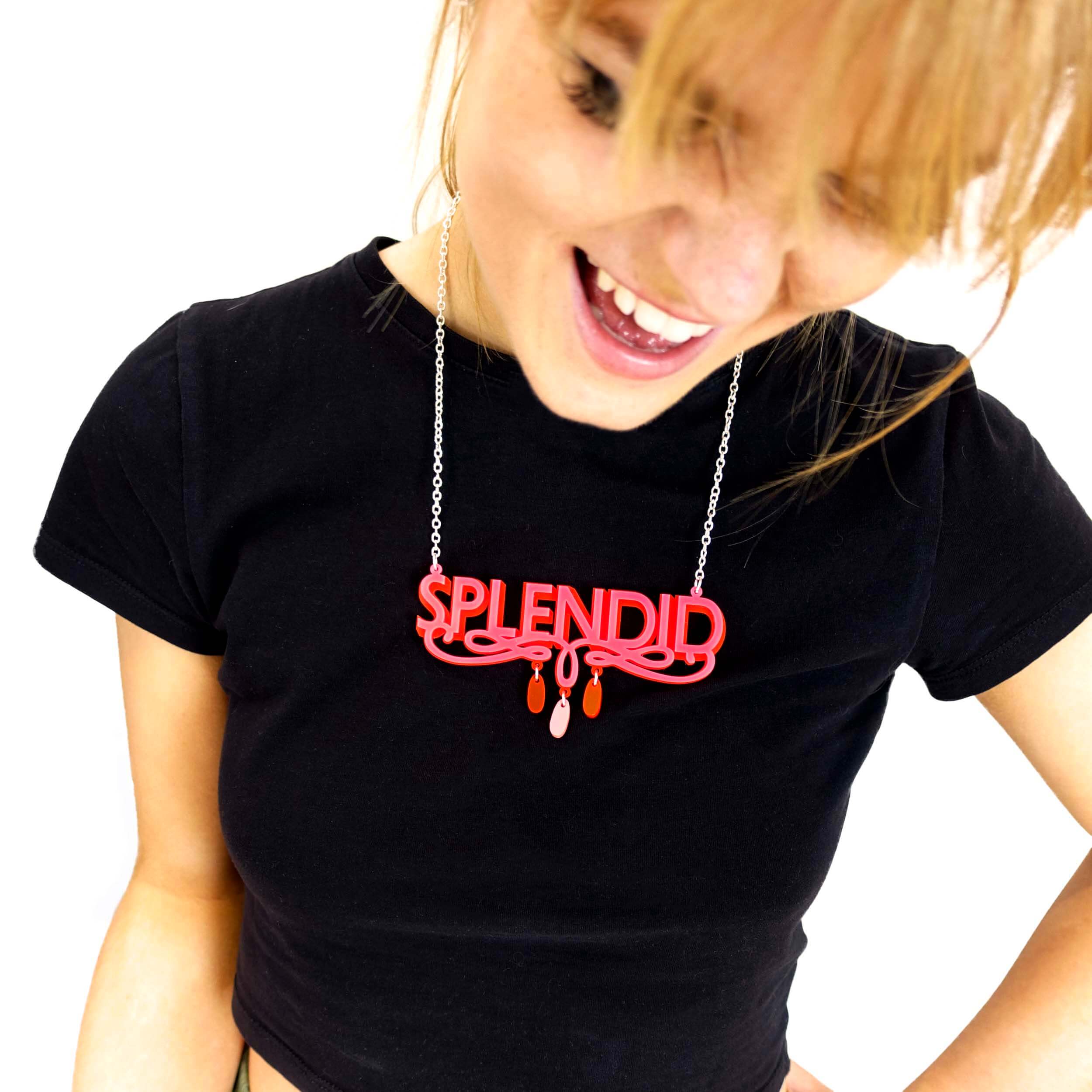 Eliza wears a hot pink and red Splendid necklace.