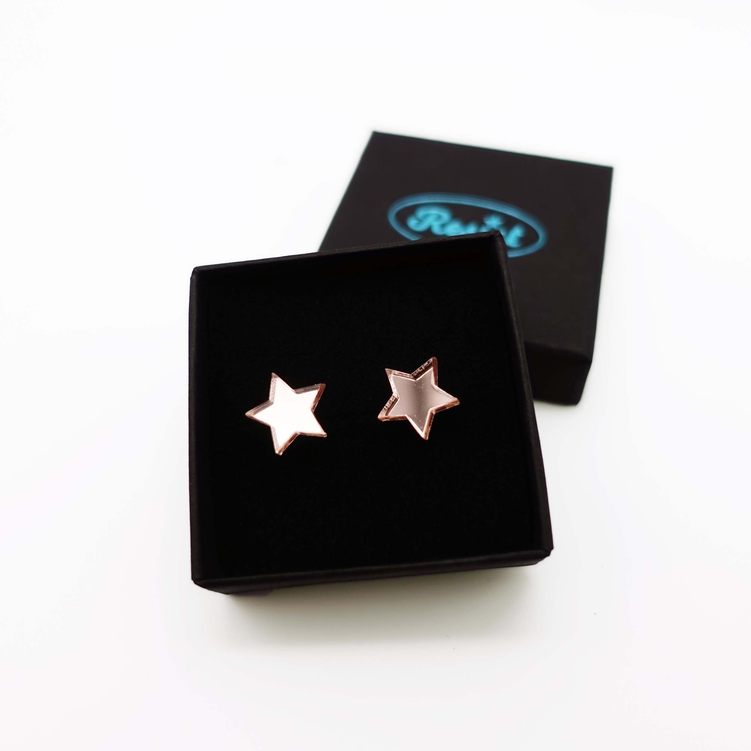 Rose gold mirror star stud earrings shown in box.