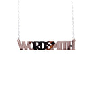A necklace that says 'Wordsmith' in rose gold mirror, shown hanging against a white background.