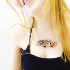 Eliza wears a rose gold mirror KILLJOY necklace.