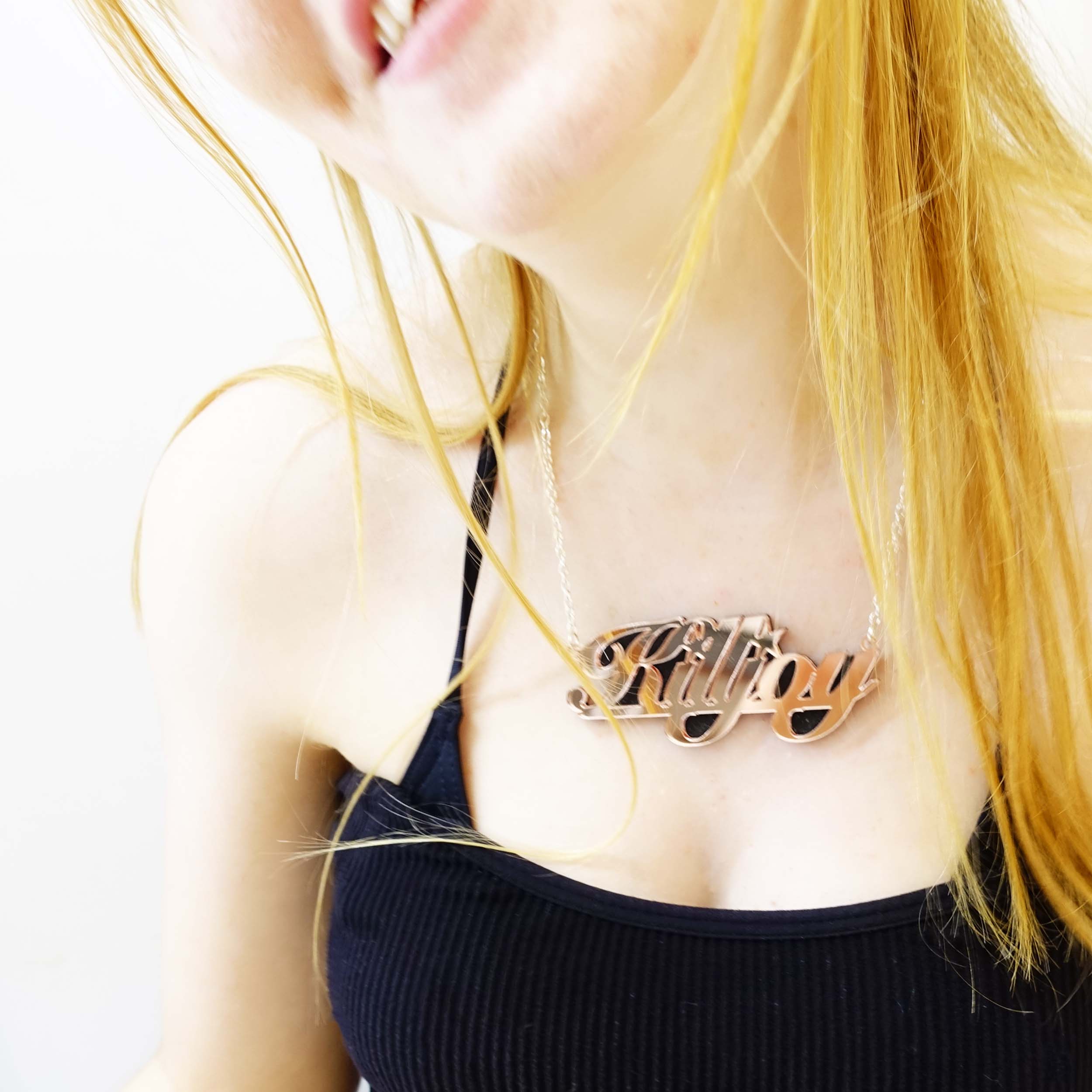 Eliza wears a rose gold mirror KILLJOY necklace.