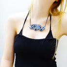 Eliza wears a slate mirror KILLJOY necklace. For feminist killjoys!