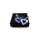 Small iridescent love heart hoop earrings shown on a Wear and Resist gift box.