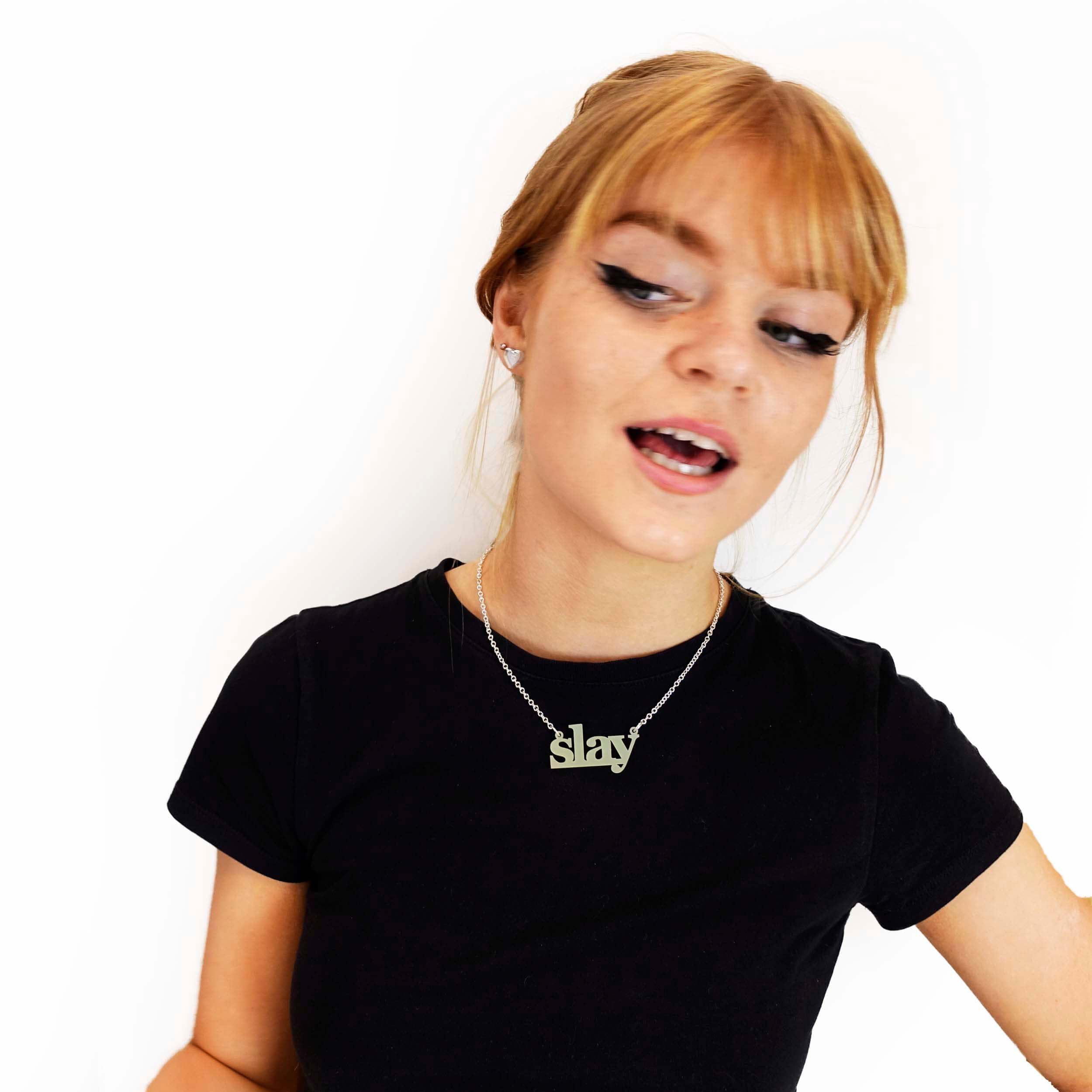 Eliza slaying while wearing a uranium yellow Slay necklace designed by Sarah Day for Wear and Resist.