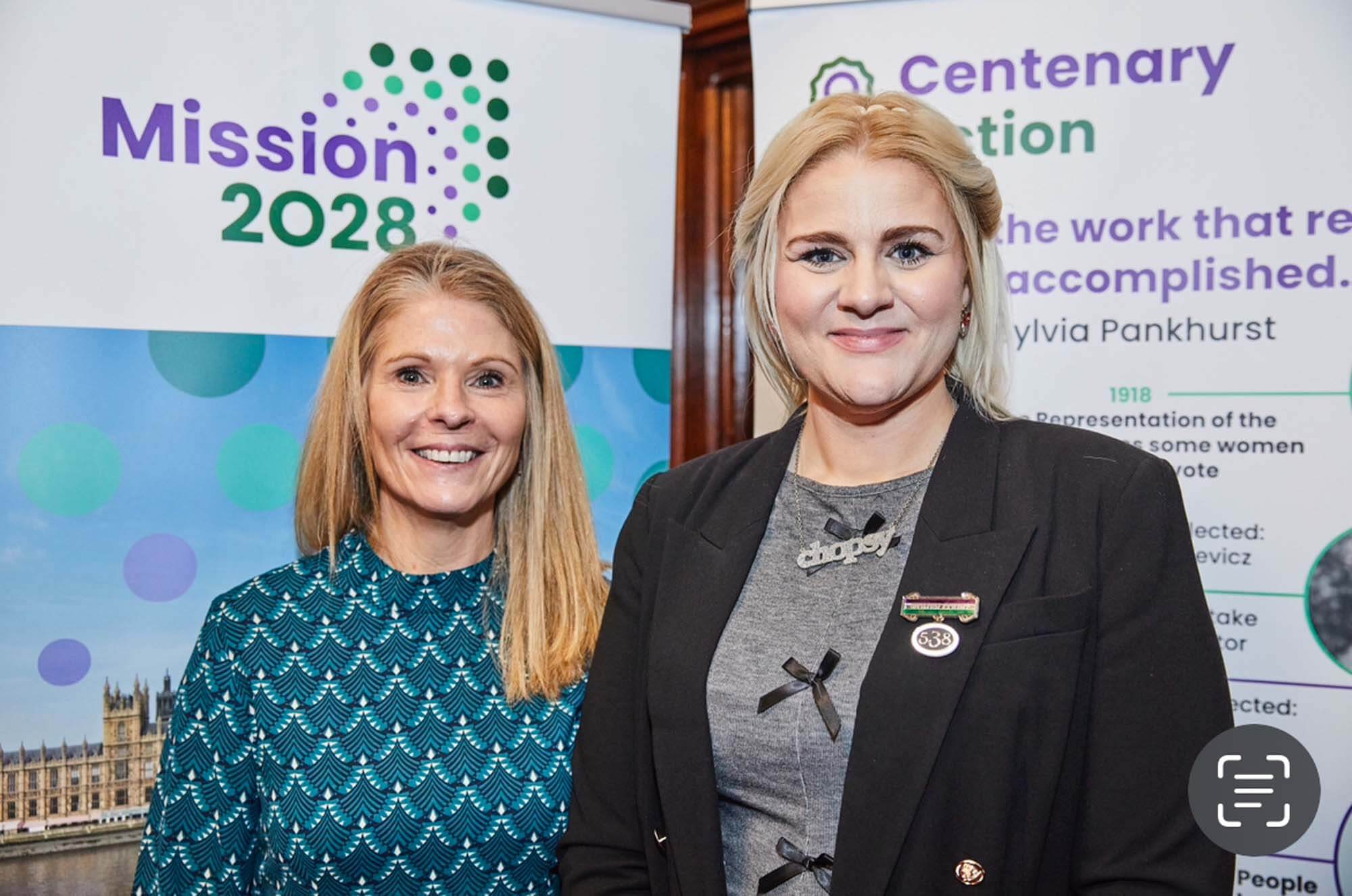 Sarah Day and Alex Davies Jones MP wearing her Women Count brooch designed for Helen Pankhurst's Centenary Action to be worn by female MPs with their number