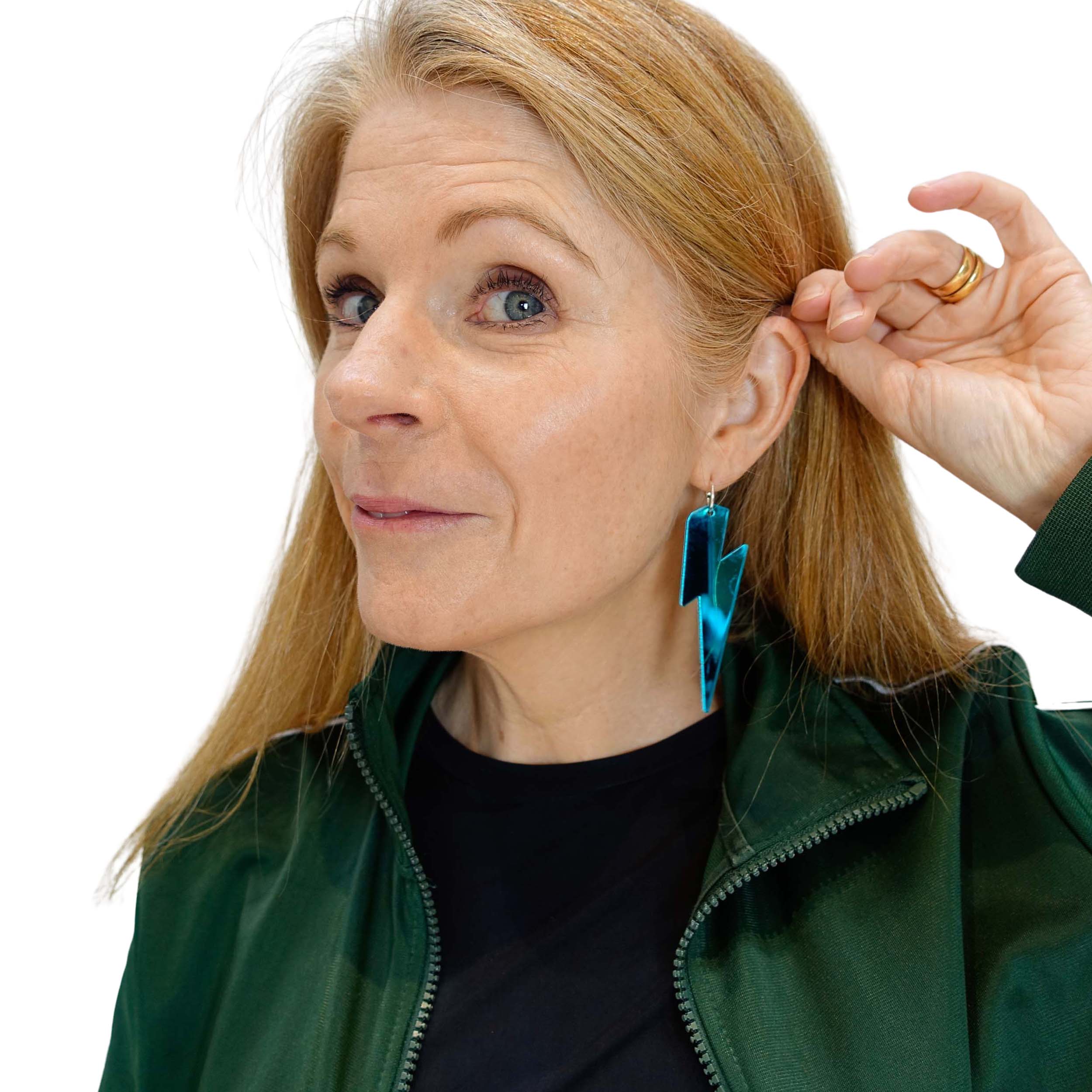 Sarah Day wears large teal Lightning Bolt hoops, designed for Wear and Resist