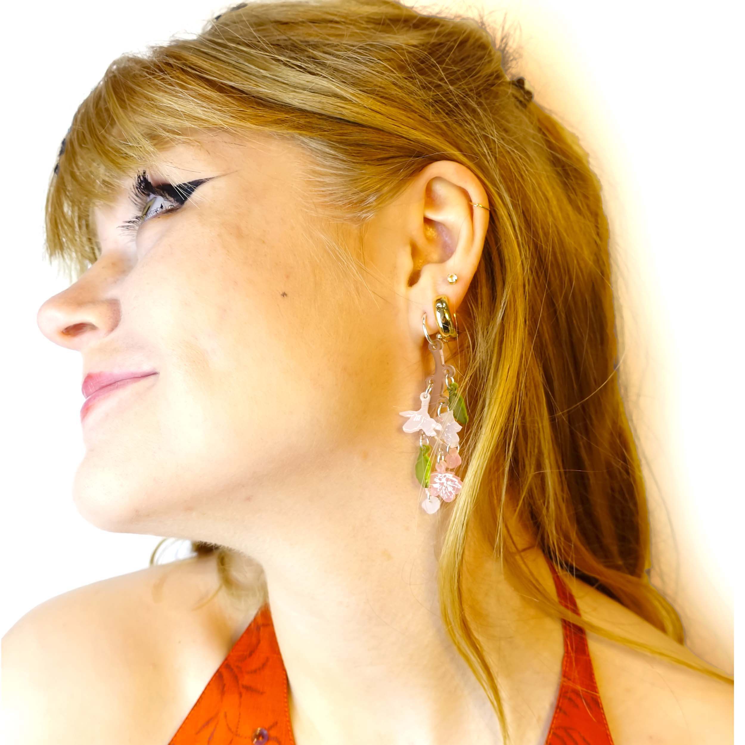Model wears cherry blossom earrings designed by Sarah Day for Wear and Resist. 