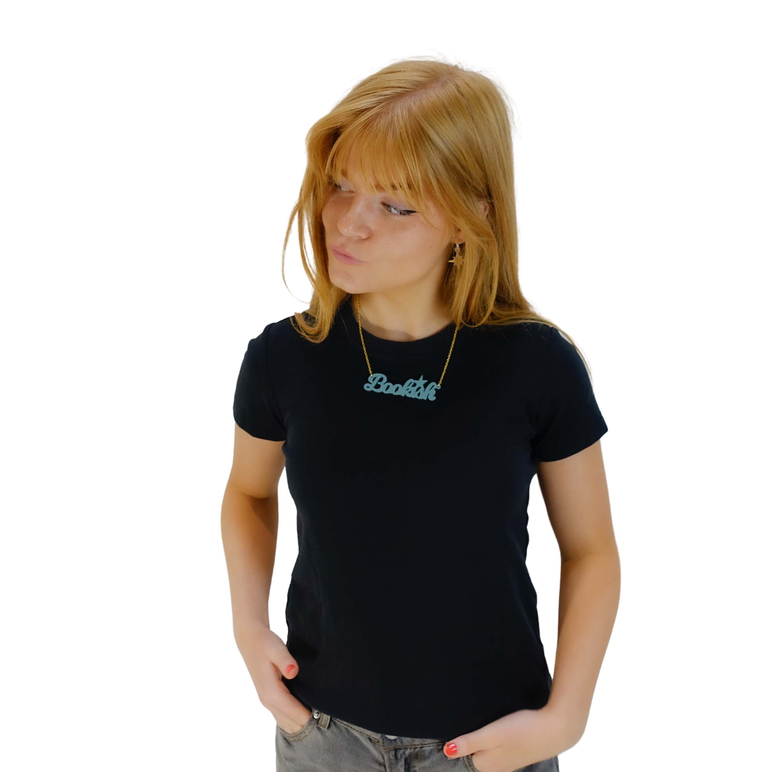 Eliza wears a glitter blue Wordsmith necklace