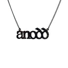Anodd necklace for Welsh difficult women in black glitter, shown hanging on a stainless steel chain. 