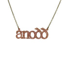 Anodd necklace for Welsh difficult women in pink fizz glitter shown hanging on an antique gold chain. 