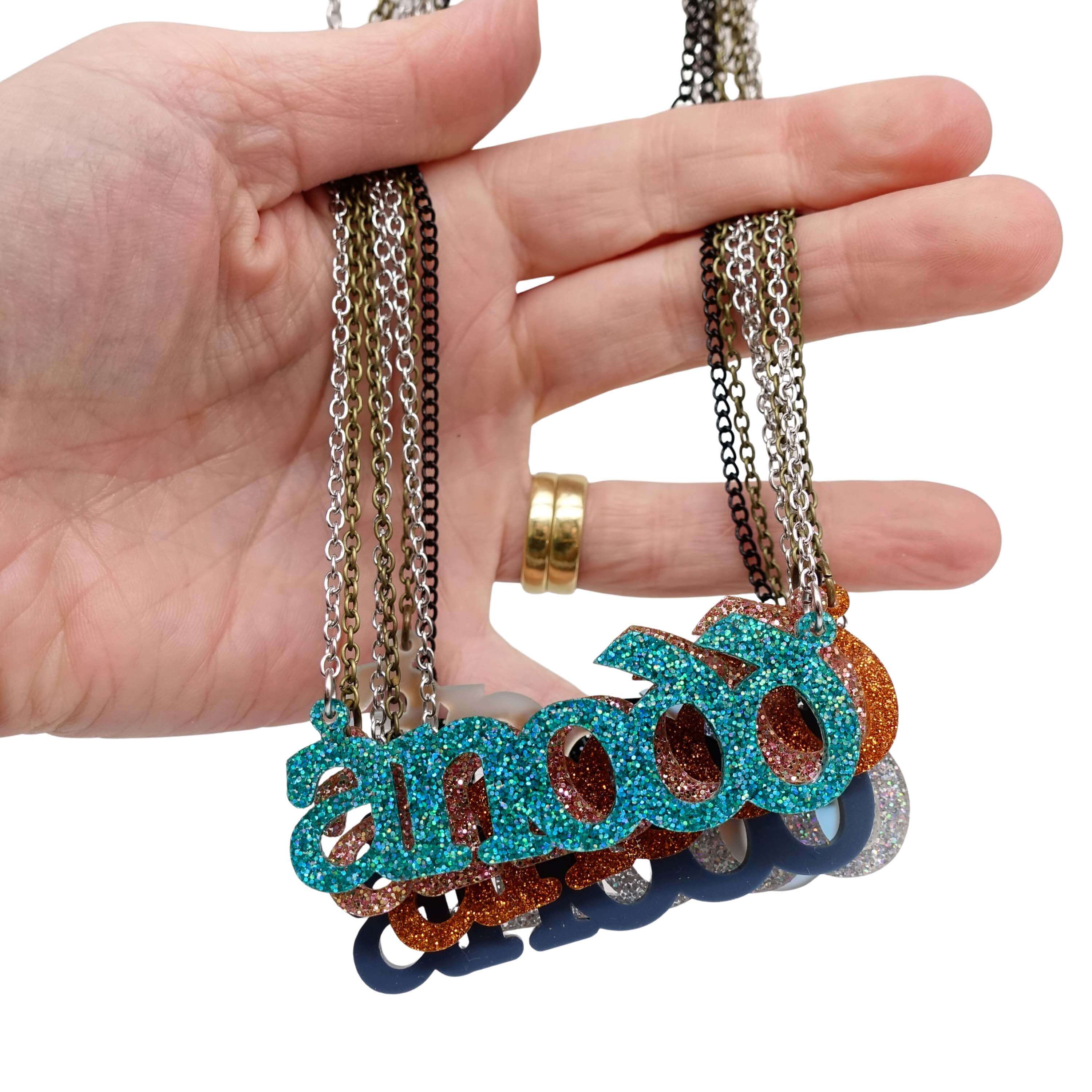 A group of Anodd necklaces  with my hand for scale. 
