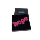 Hope statement necklace in shot pink glitter, shown in a Wear and Resist gift box.