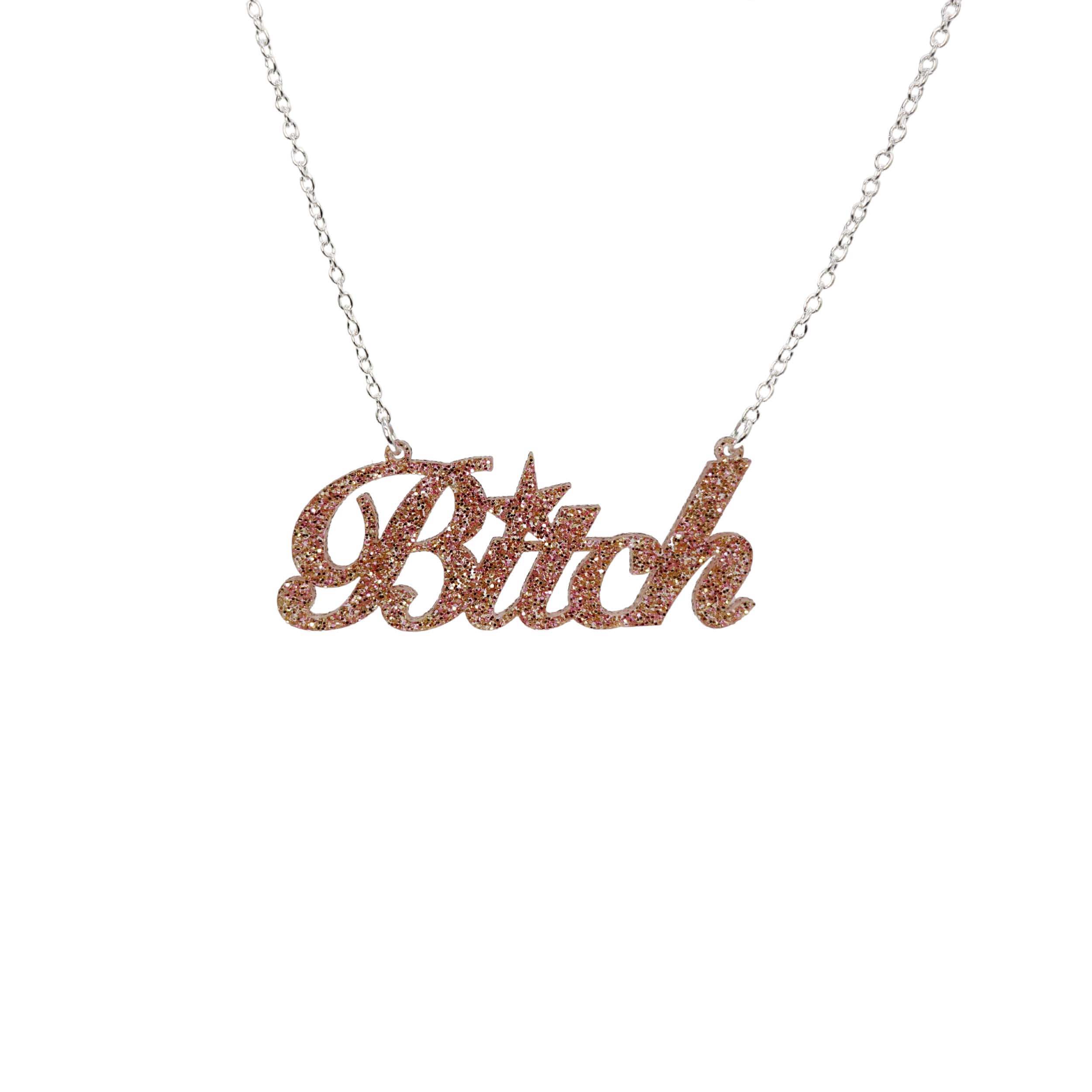 B*tch necklace in pink fizz glitter shown hanging against a white background. 