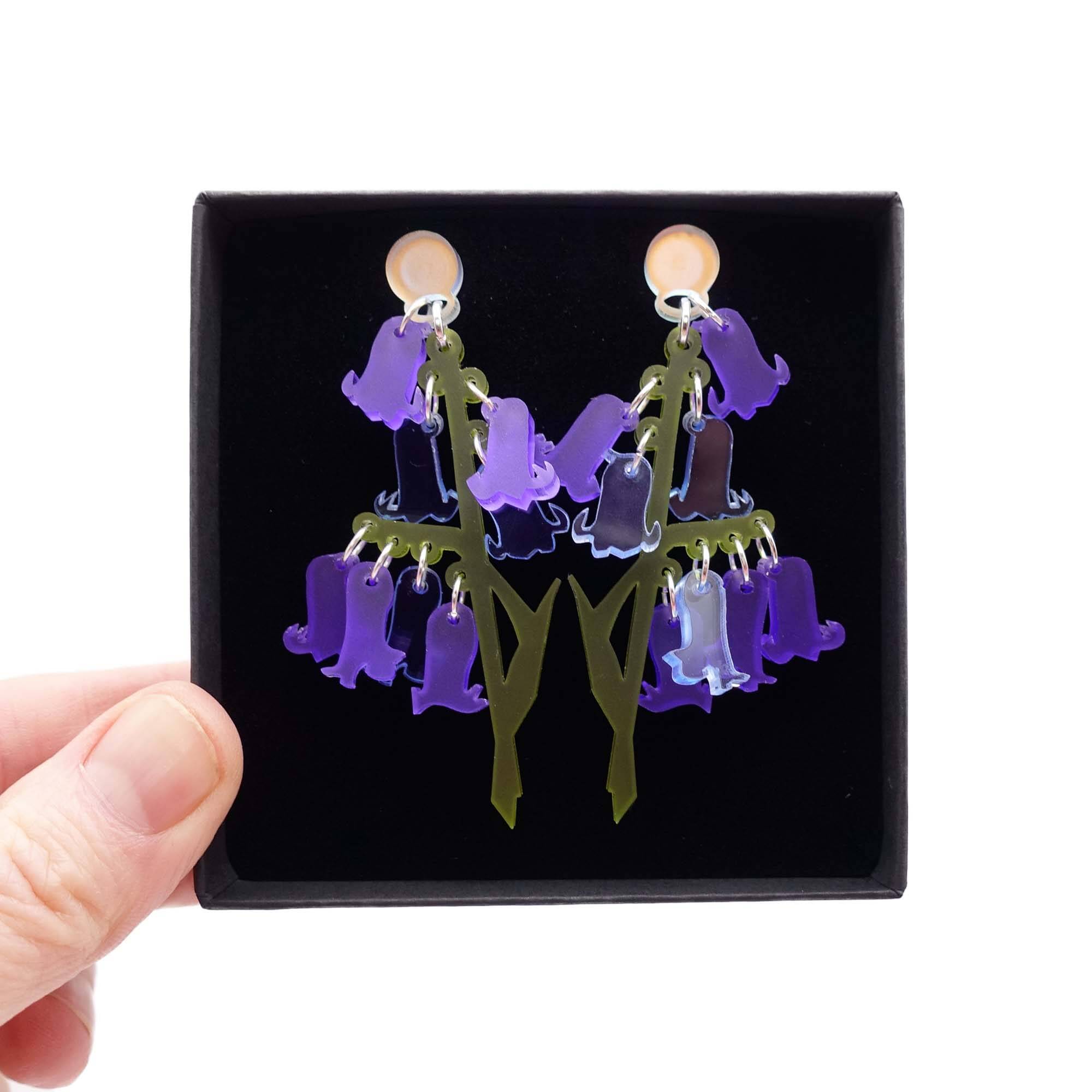 Bluebell earrings shown held up in a Wear and Resist gift box. 