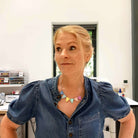 Sarah wears the C*nting Bunting necklace in the studio. 