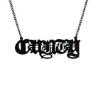 Big C*nty necklace in matte black shown hanging on a black chain. 
