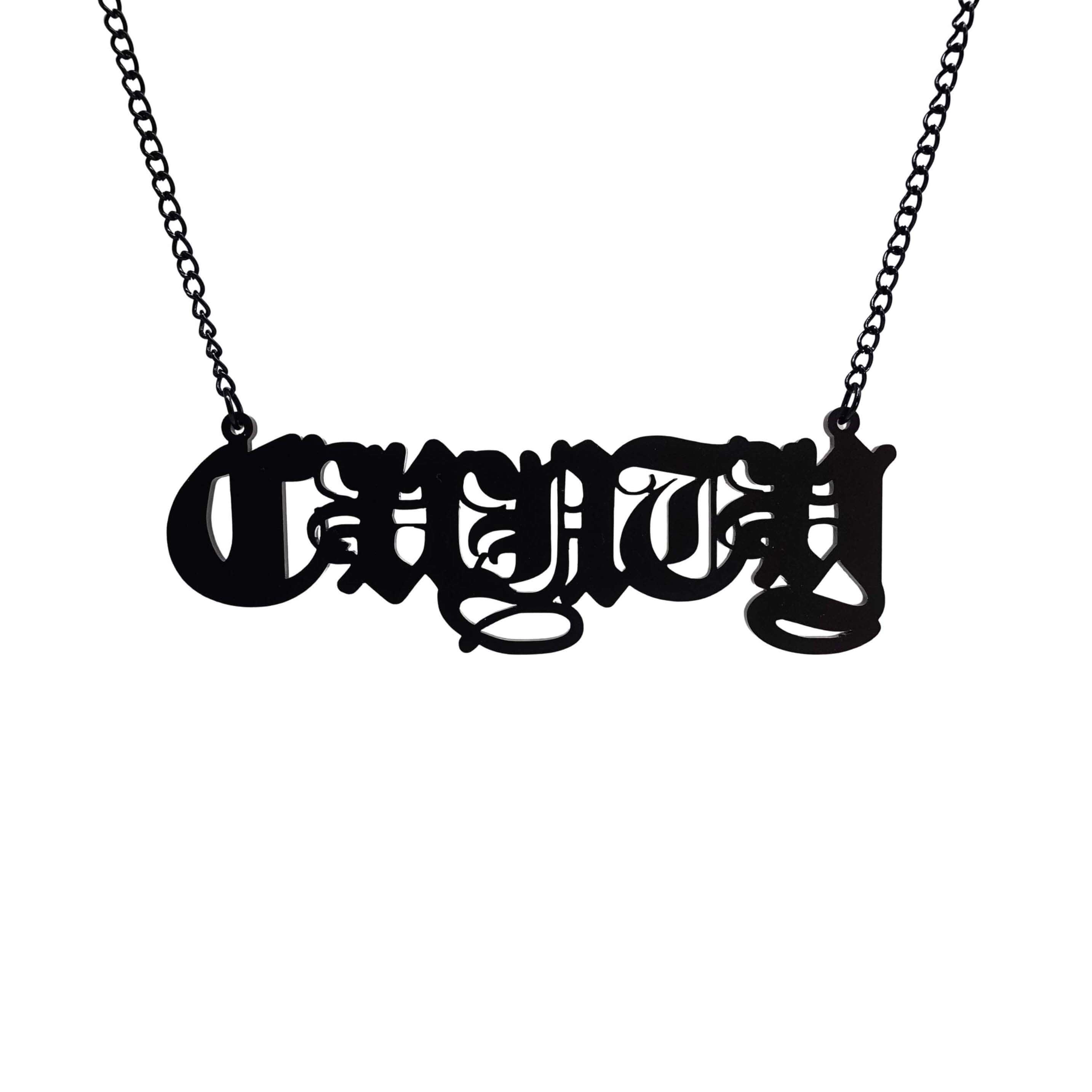 Big C*nty necklace in matte black shown hanging on a black chain. 