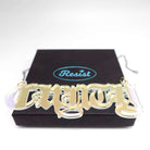 Big C*nty necklace in matte iridescent shown on a Wear & Resist gift box.  