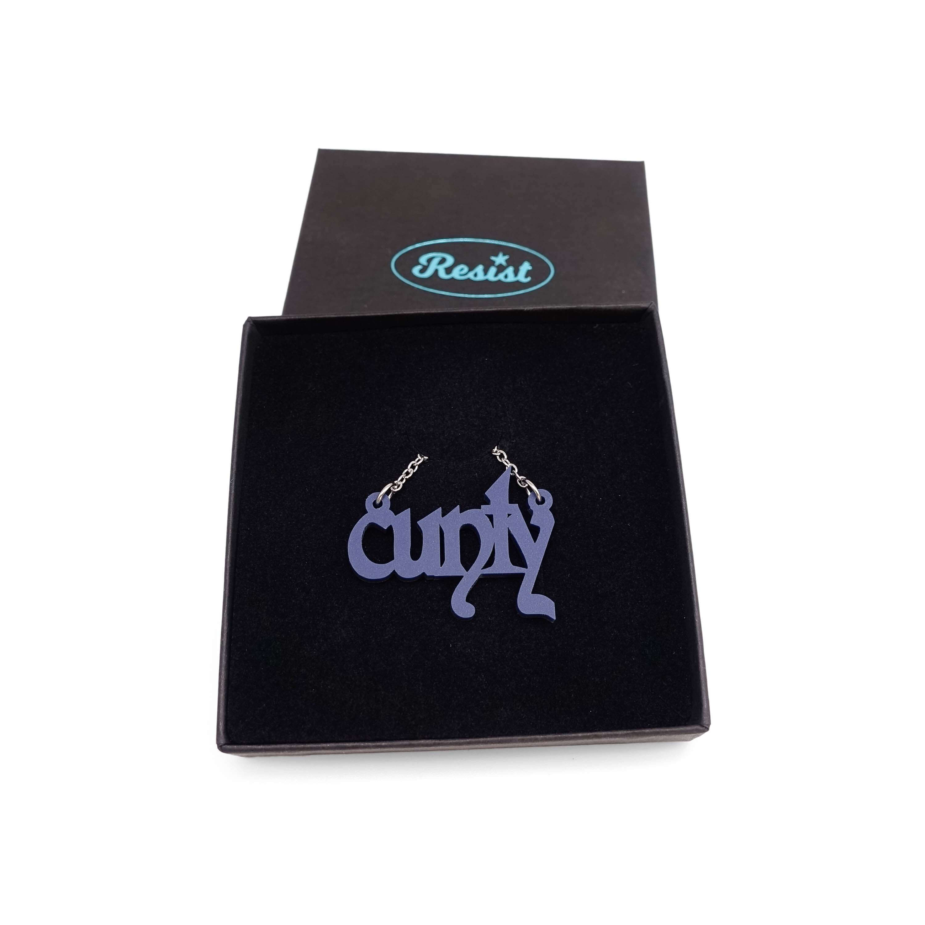 Little CUNTY necklace in matte navy shown in a Wear & Resist gift box. 