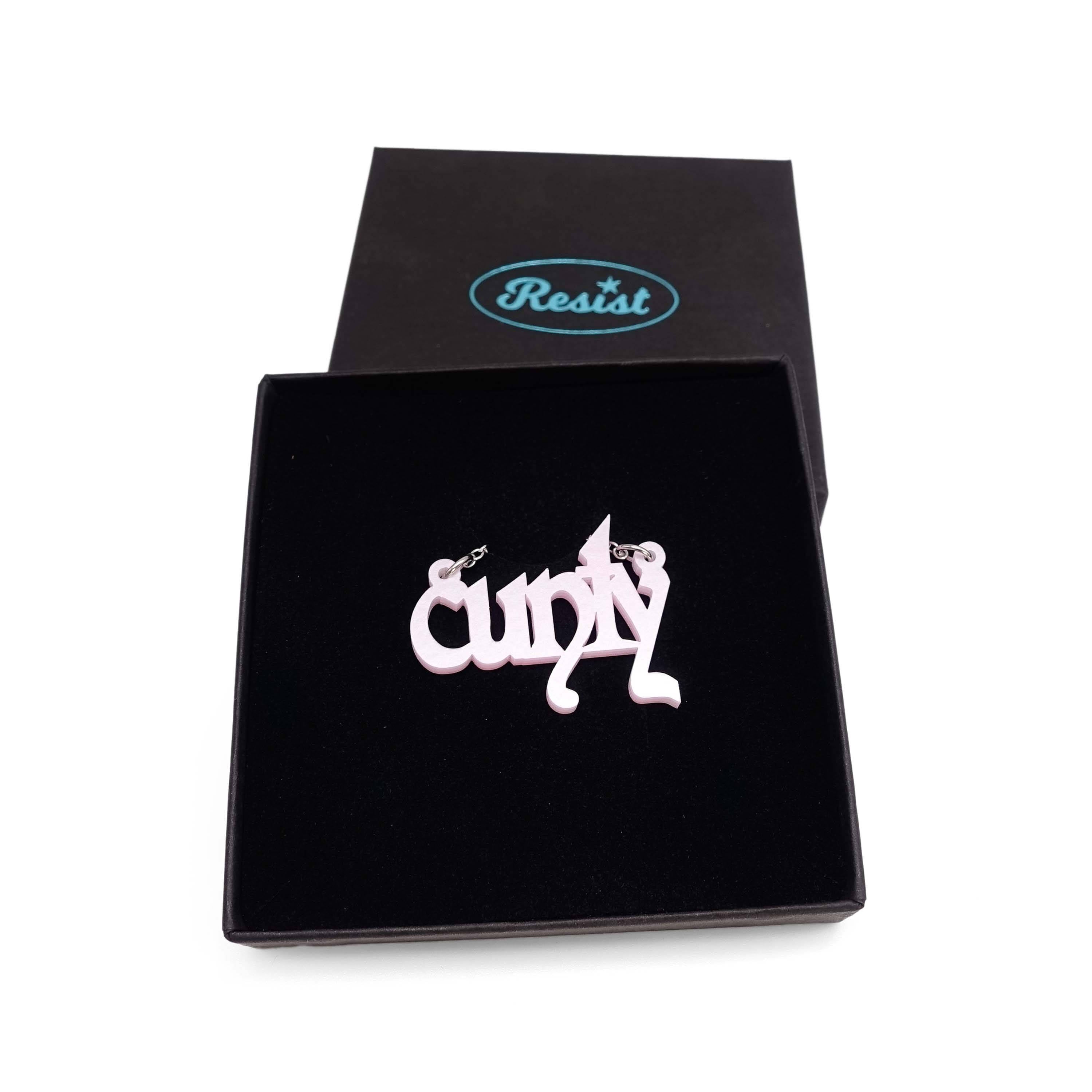 Little CUNTY necklace in shell pink shown in a Wear & Resist gift box. 