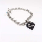 Stainless steel charm bracelet with slate Be Brave glow-in-the-dark heart charm. 