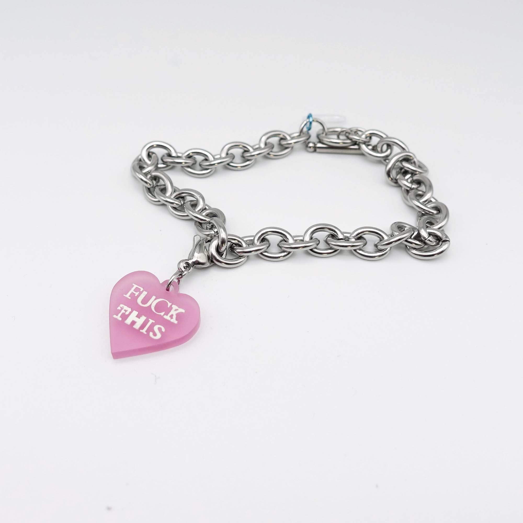 Stainless steel charm bracelet with pale pink F*ck This glow-in-the-dark heart charm. 