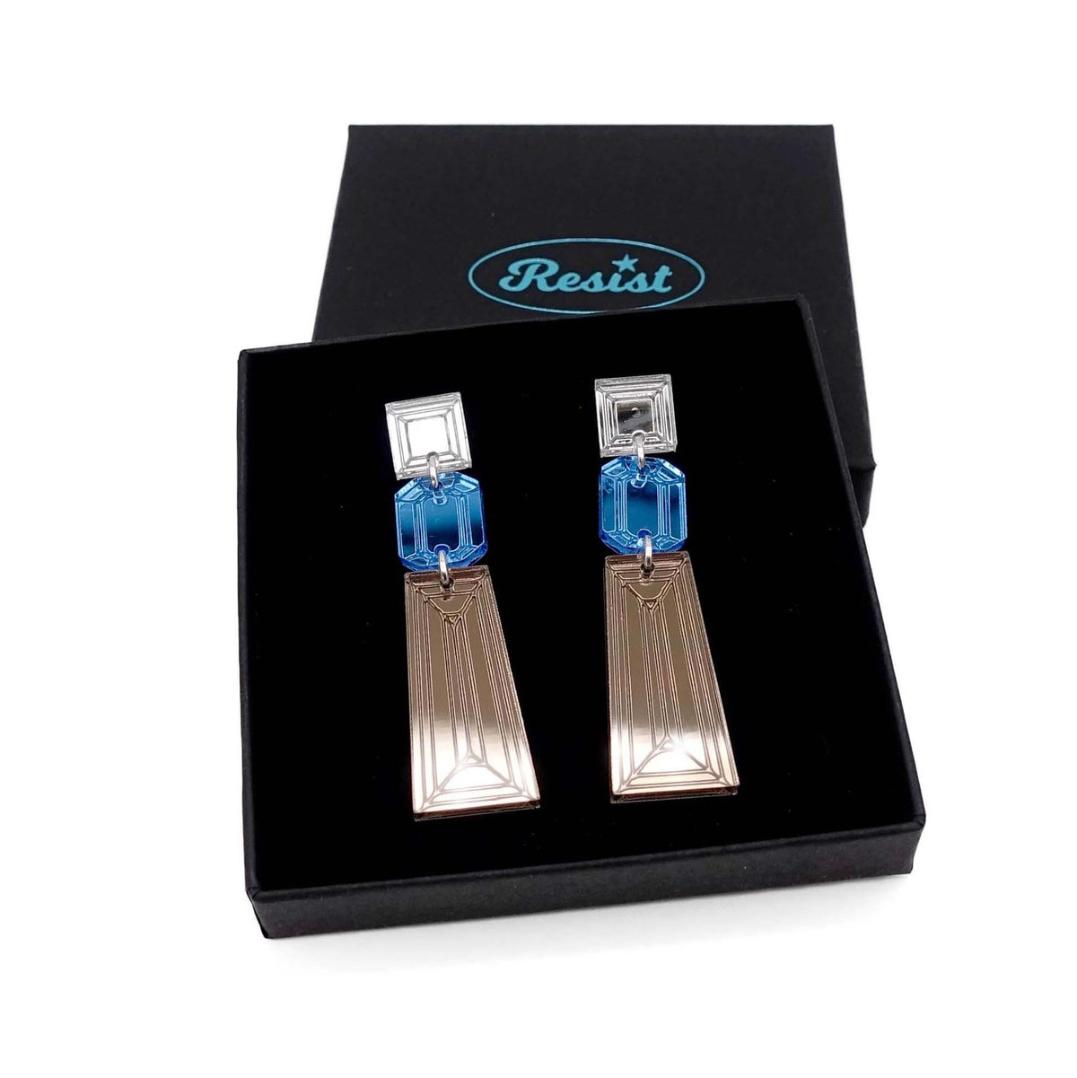 Long Deco drop earrings in bronze, sky and silver mirror shown in a Wear and Resist gift box. 