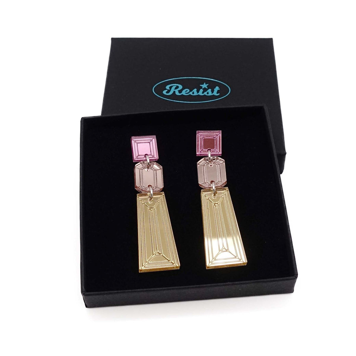 Long Deco drop earrings in gold, rose gold and pink mirror shown in a Wear and Resist gift box. 