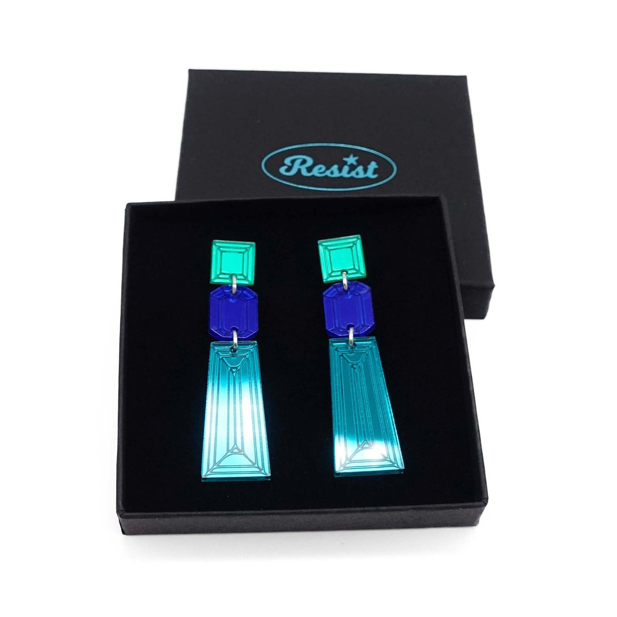 Long Deco drop earrings in teal, electric blue and electric green mirror shown in a Wear and Resist gift box. 