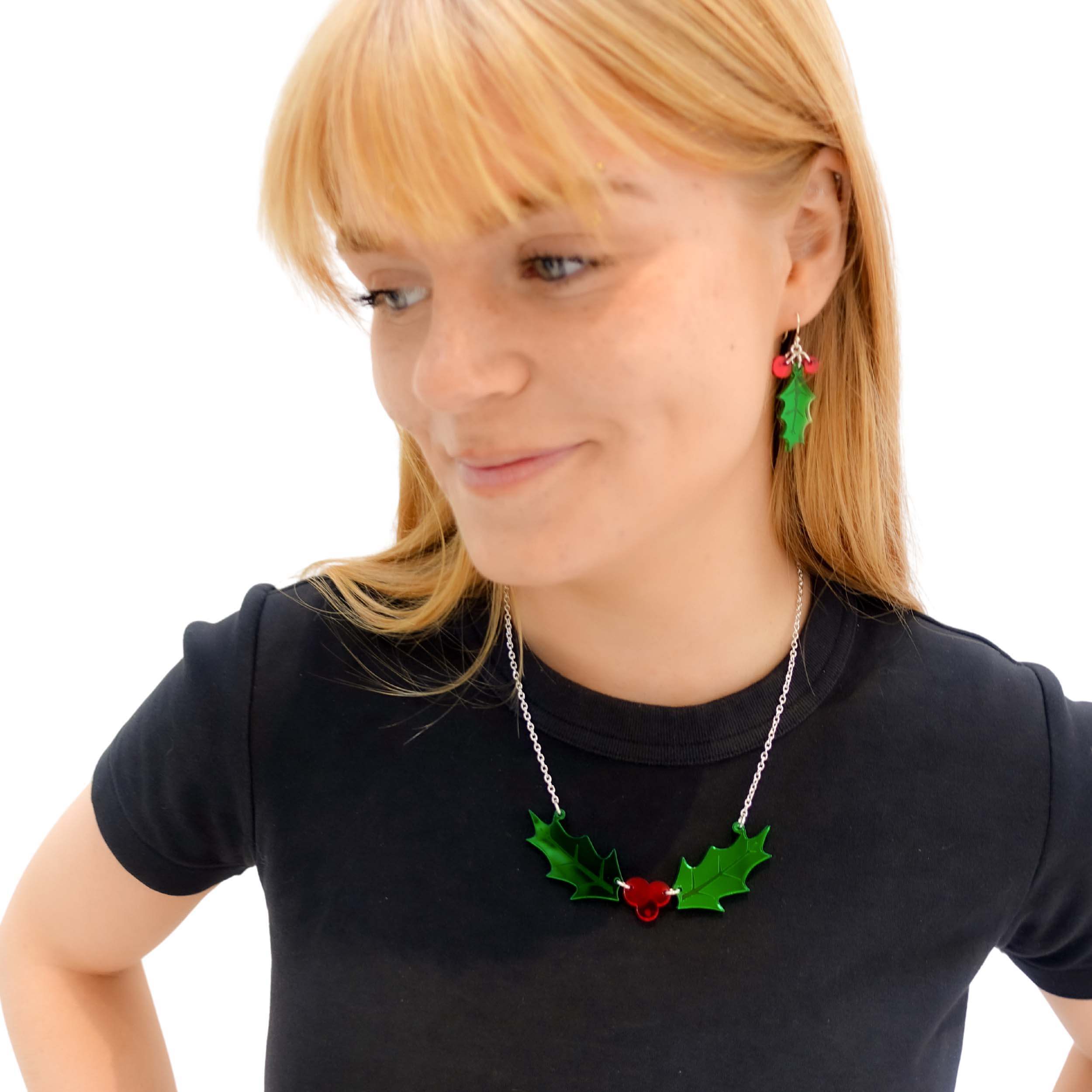 Eliza wears the Holly necklace with matching Delicate Holly earrings, both from the Christmas Collection at Wear and Resist. 