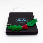 The Holly necklace resting on a Wear and Resist gift box. 