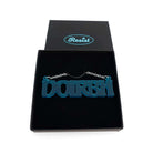 DOIRBH Gaelige necklace for Irish difficult women in teal frost, shown in a Wear & Resist gift box. 