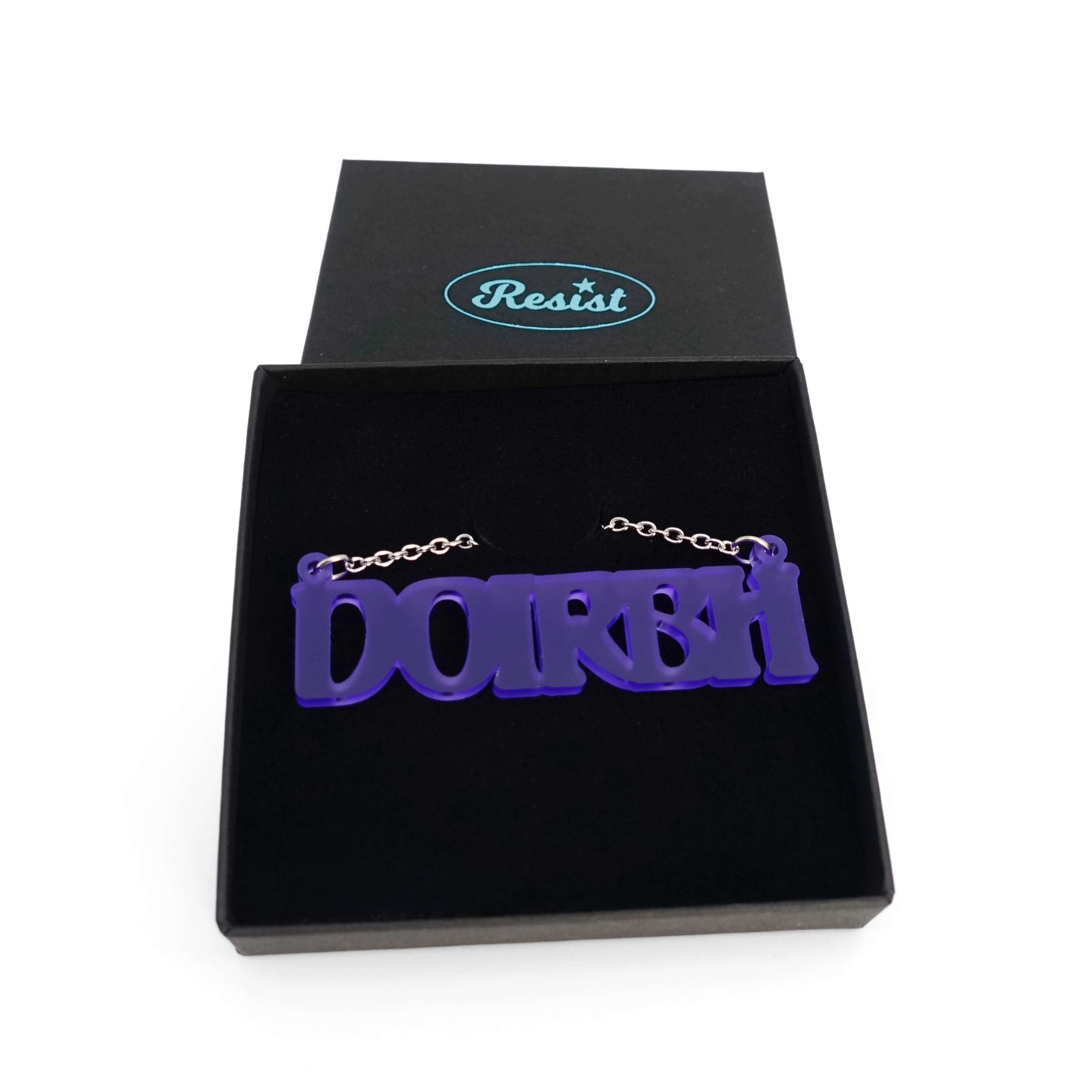 DOIRBH Gaelige necklace for Irish difficult women in violet frost, shown in a Wear & Resist gift box. 