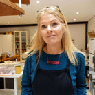 Sarah wears an oxblood red DÒCHAS Irish Gaelige hope necklace in her studio. 
