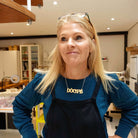 Sarah wears a matte iridescent Irish Gaelige DÒCHAS necklace in her studio. 