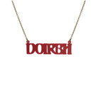 DOIRBH Gaelige necklace for Irish difficult women in oxblood red, shown hanging on an antique gold chain. 
