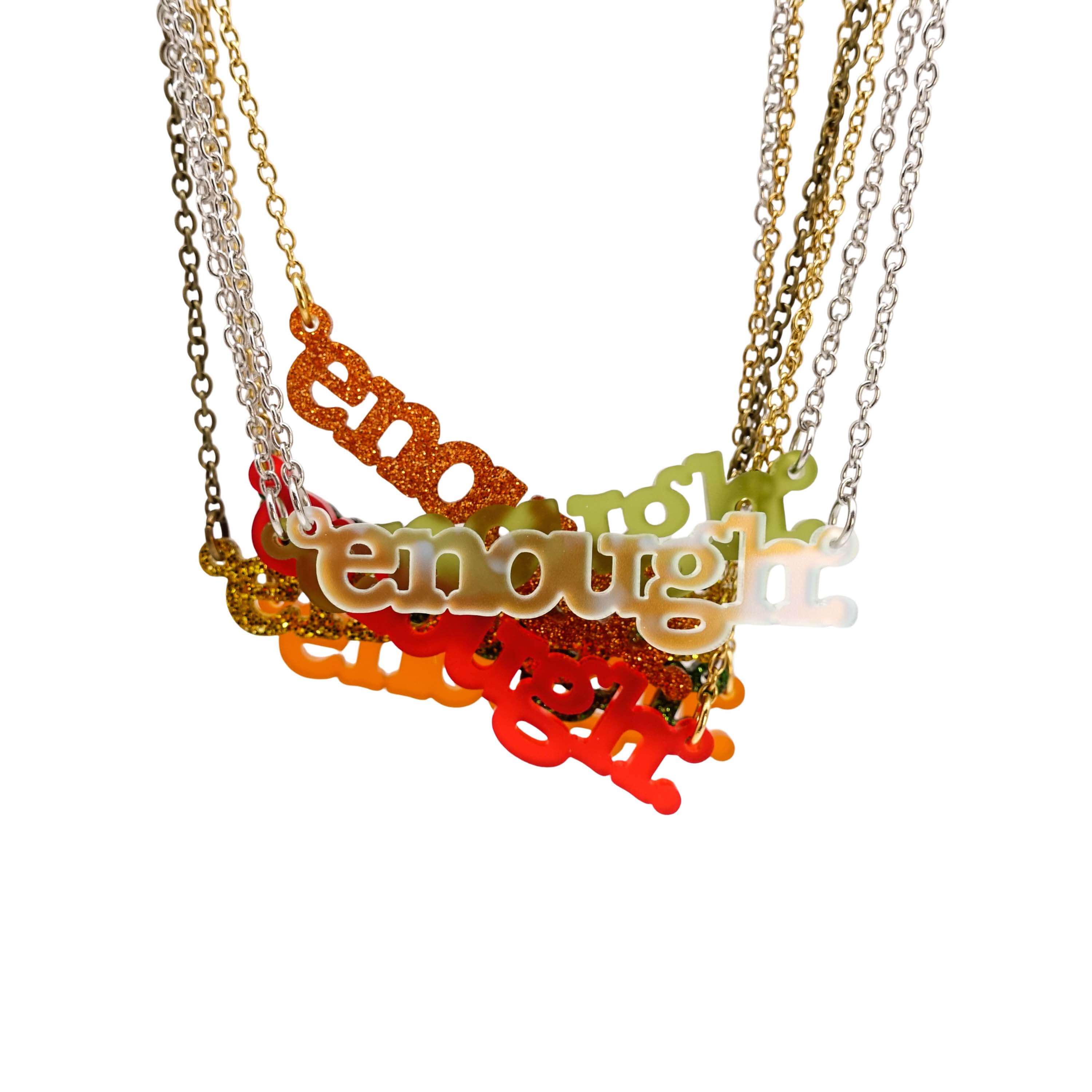 Typewriter font Enough necklaces in new Autumn colours shown hanging against a white background. 