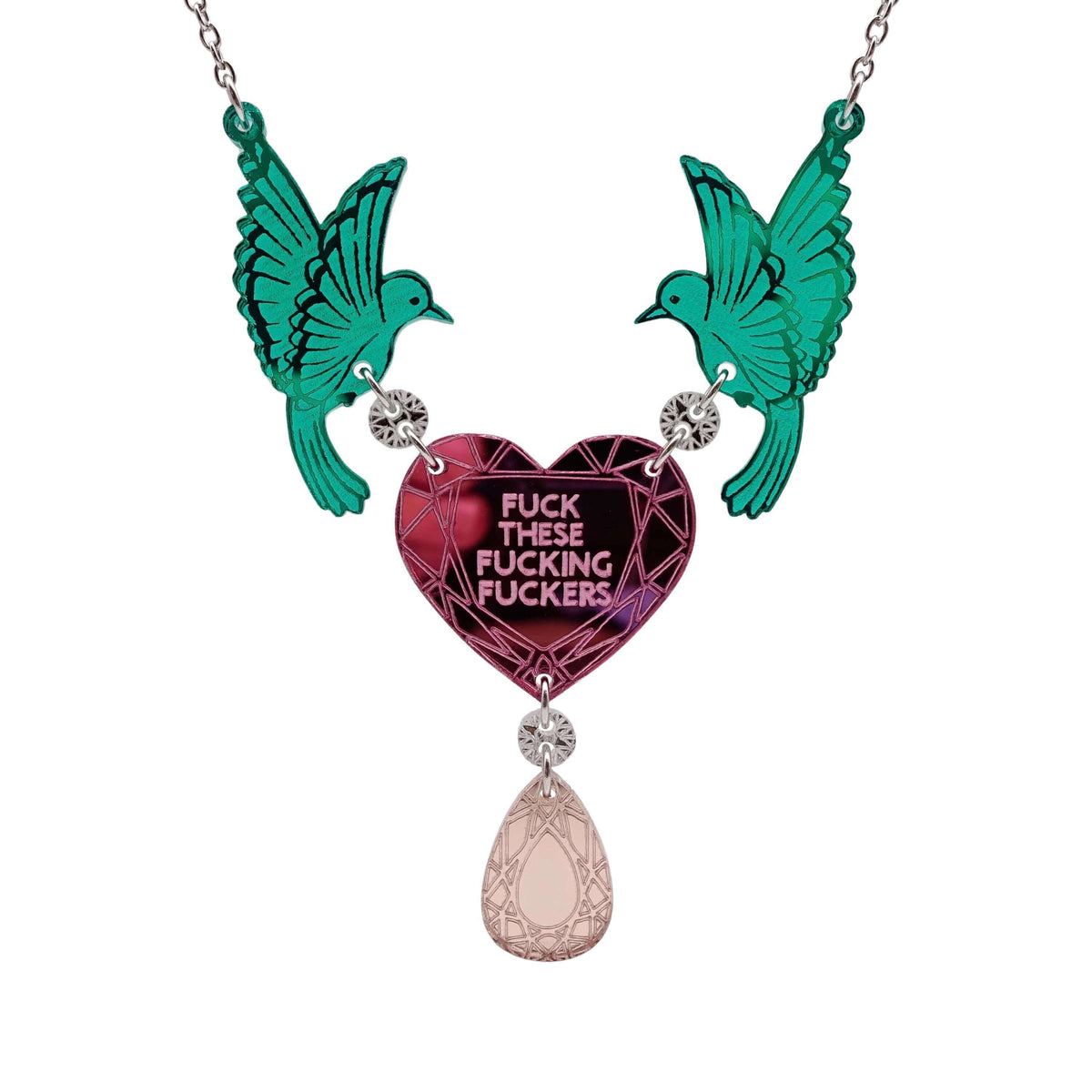 A mirror acrylic necklace with two green birds holding a pink heart that says 'F*ck these F*cking F*ckers' with a rose gold 'jewel' hanging from the centre. 