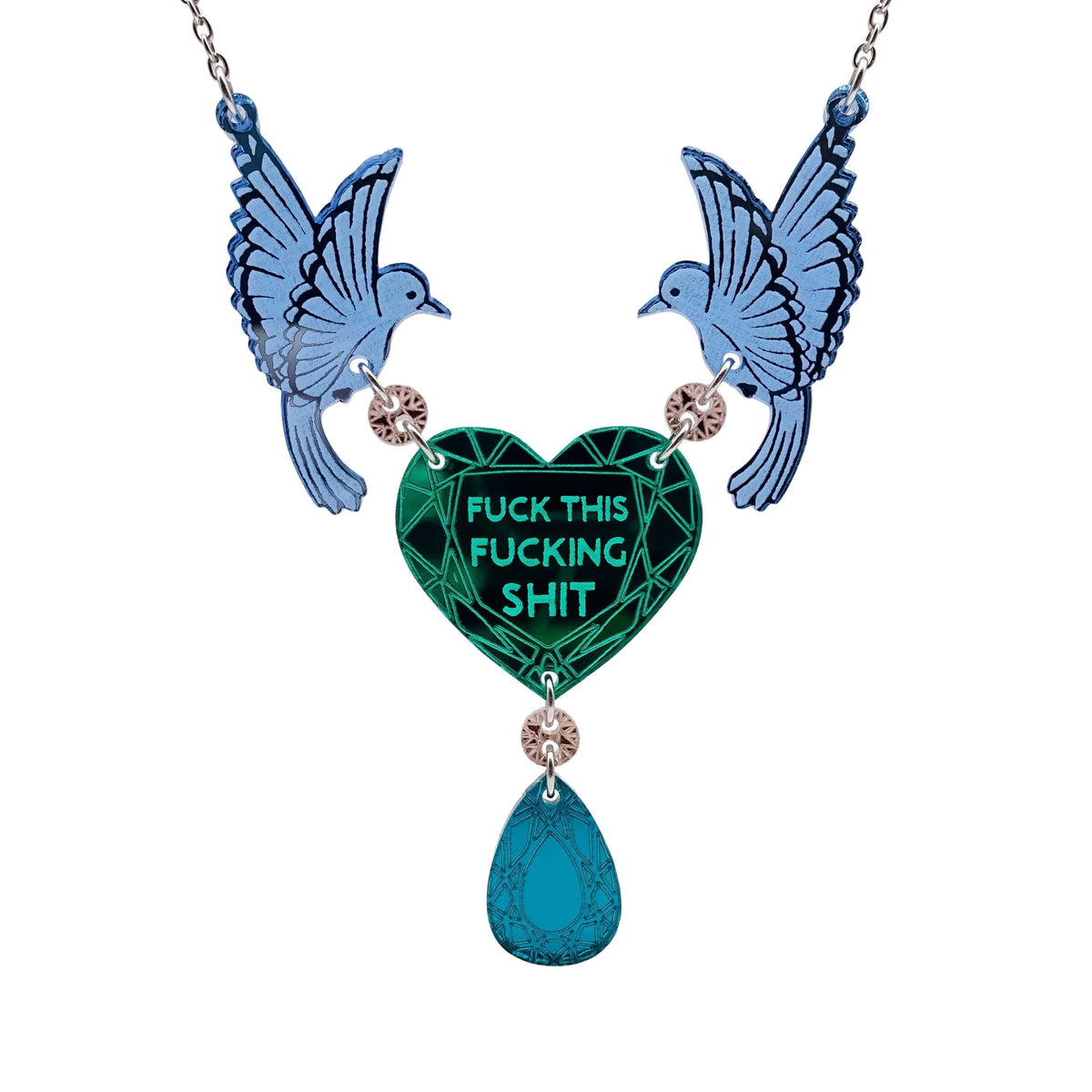 A mirror acrylic necklace with two blue birds holding a green heart that says 'F*ck this F*cking Sh*t' with a teal 'jewel' hanging from the centre. 