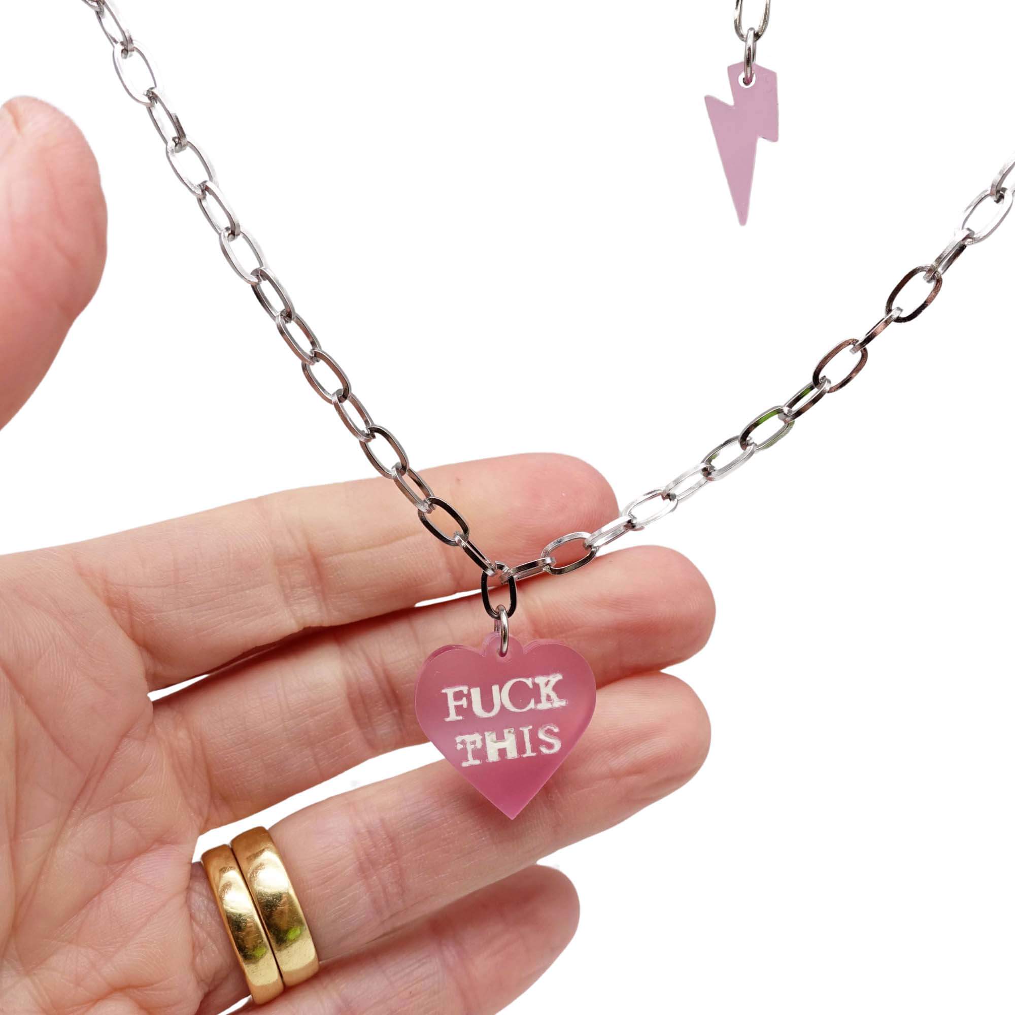 Glow-in-the-dark F*ck This punk necklace in pale pink frost with matching lightning bolt on a stainless steel chain. 