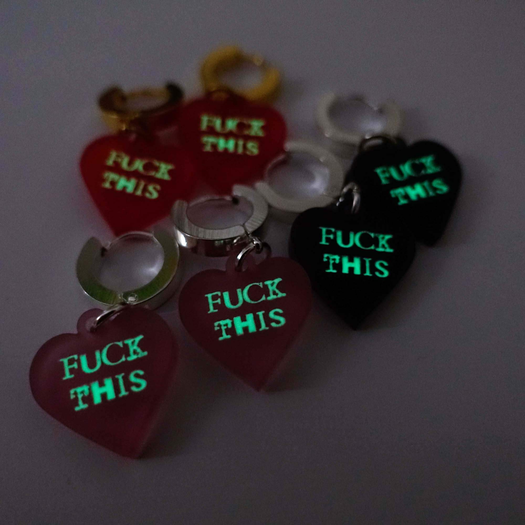 F*ck This huggie hoop earrings shown glowing in the dark. You can recharge them with your phone and they gold their glow! 