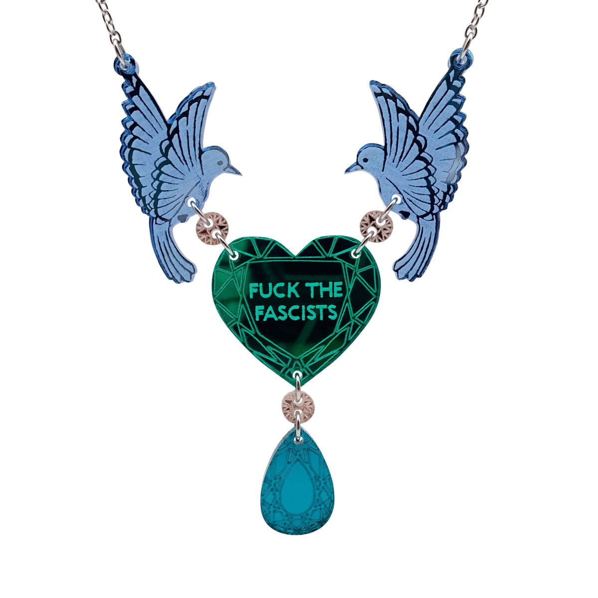 A mirror acrylic necklace with two blue birds holding a green heart that says 'F*ck the Fascists' with a teal 'jewel' hanging from the centre. 