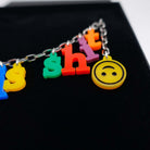 A close up of the 'not happy' emoji on the *Fck this Sh*t Alphabet necklace.