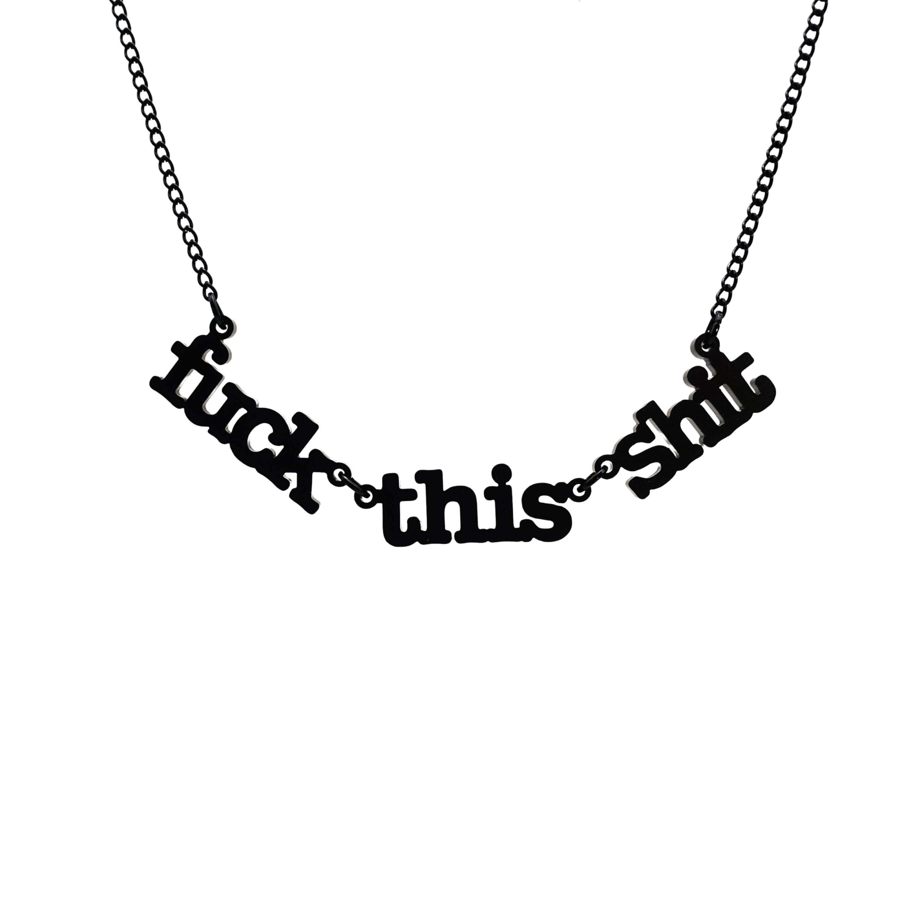 F*ck this Sh*t necklace in matte black shown hanging on a black chain against a white background.