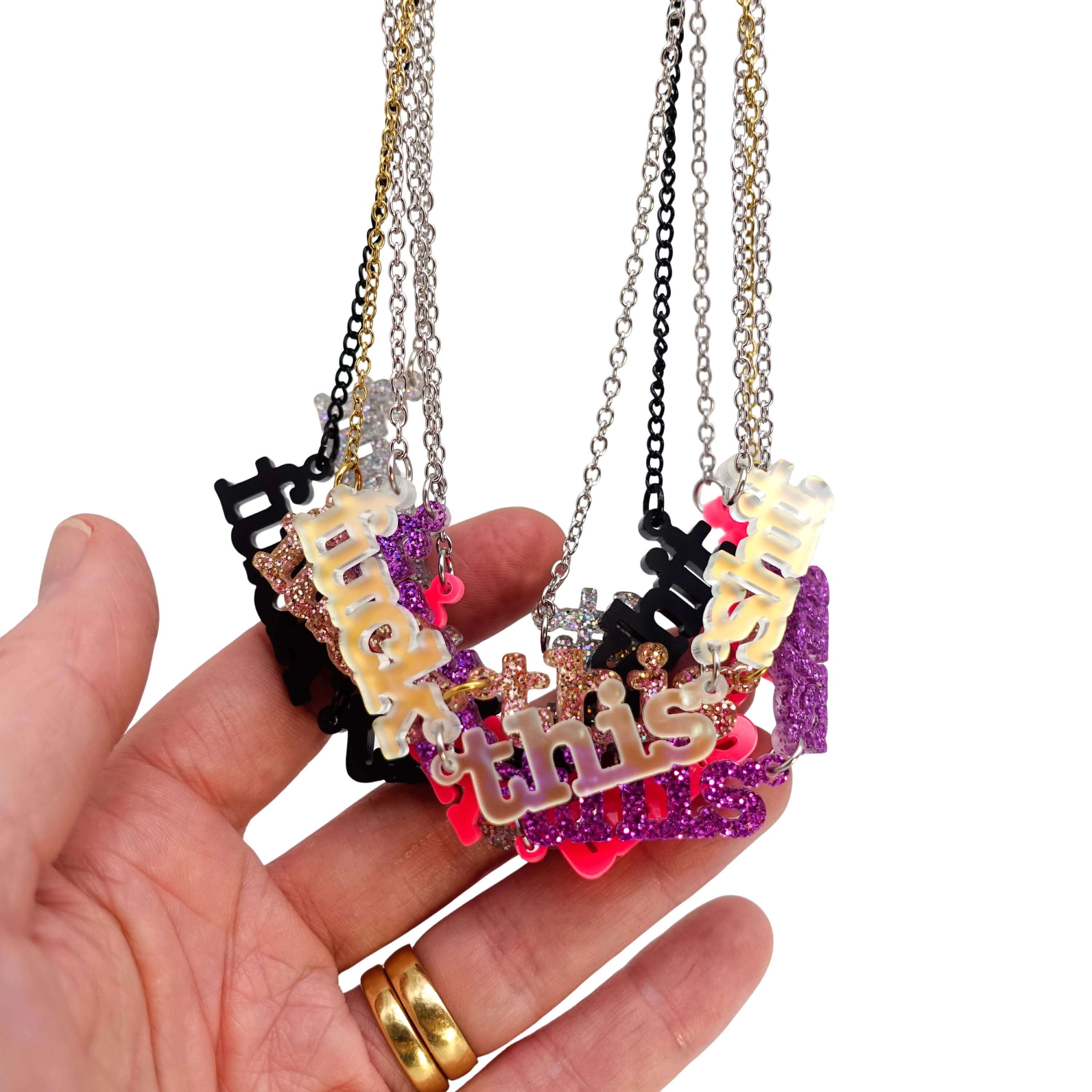 A group shot of all the F*ck this Sh*t necklaces 