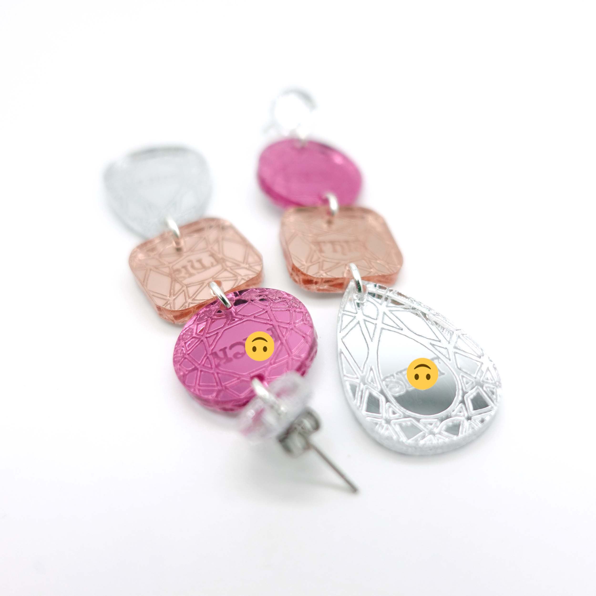 Sweary austerity jewel earrings in pink, rose gold and silver shown  on a white background. 